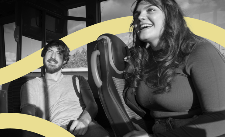 man and woman smiling on the bus